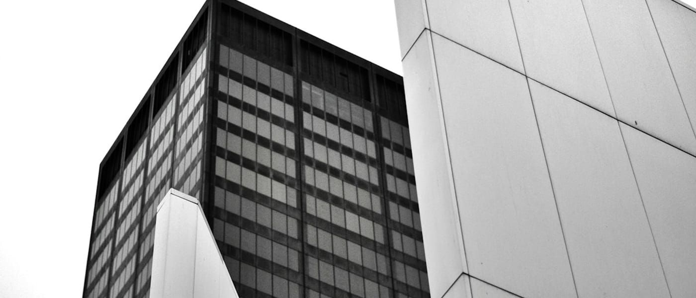 Grayscale concrete building against an open sky