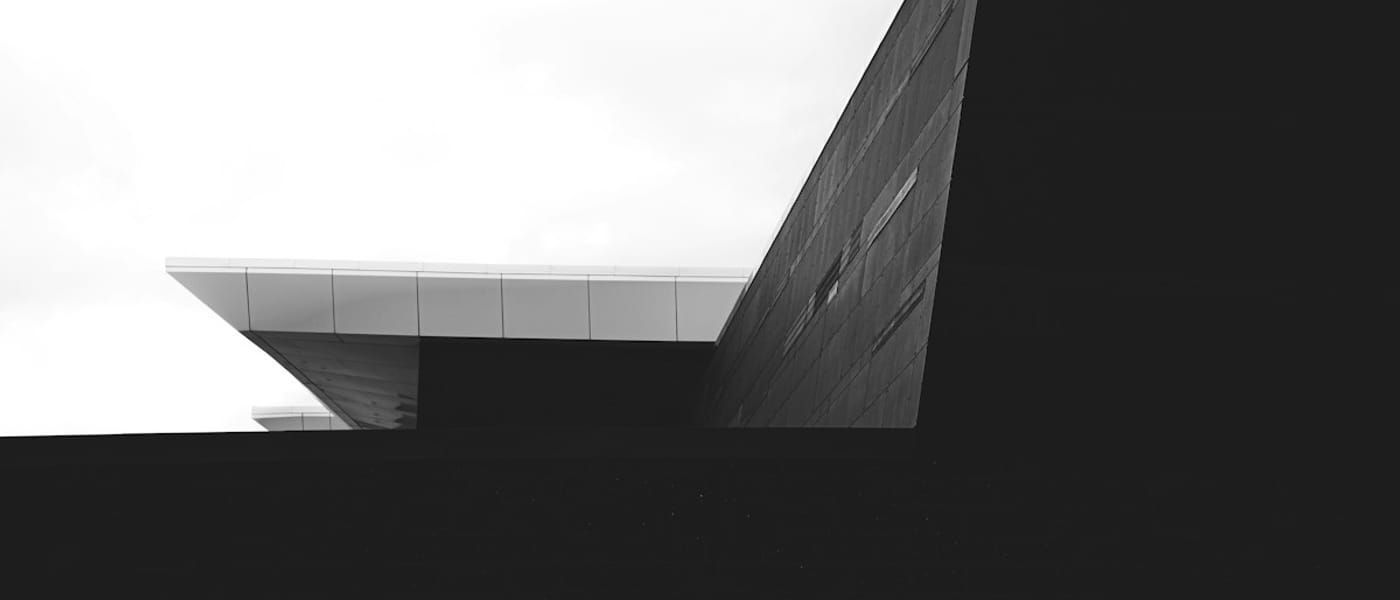 Minimal grayscale building volume against a bright sky