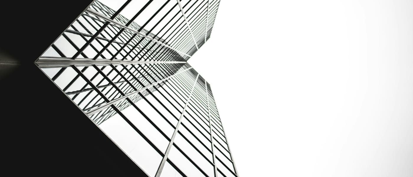 Symmetrical mirror-glass tower seen from below