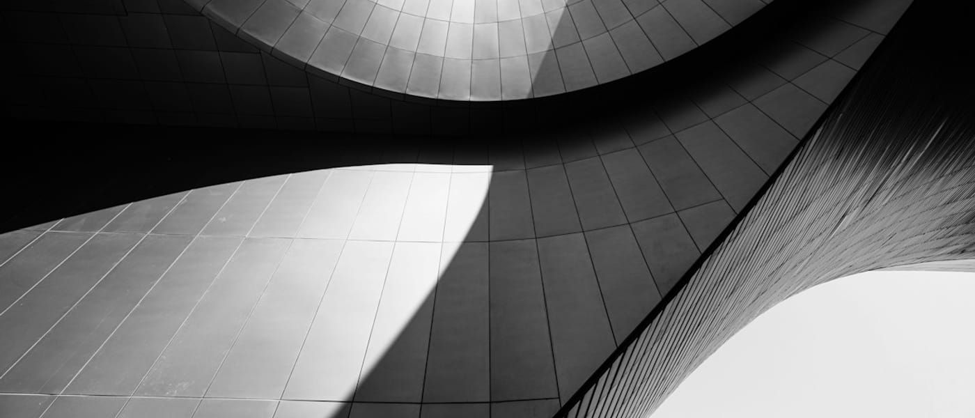 Abstract architectural lines converging towards a circular opening