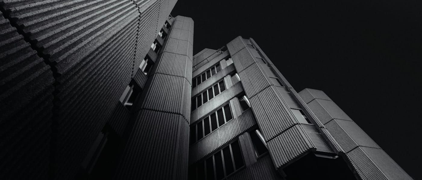 Monochrome ribbed facade of a tall building